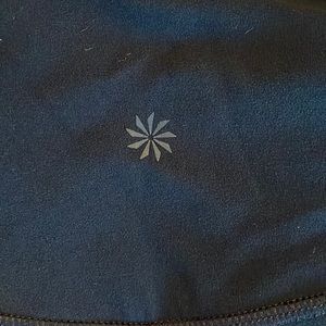 Black Athleta leggings with holes and mesh along the sides